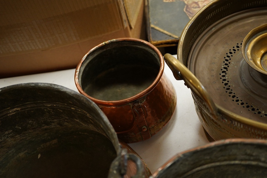 A collection of four copper vessels and another brass, largest 32cm